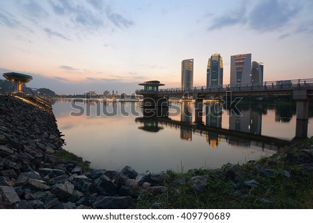 beautiful sunset during blue hour at Putrajaya Lakeside, Malaysia. hotel and building reflection on the lake. modern jetty. soft and dramatic cloud