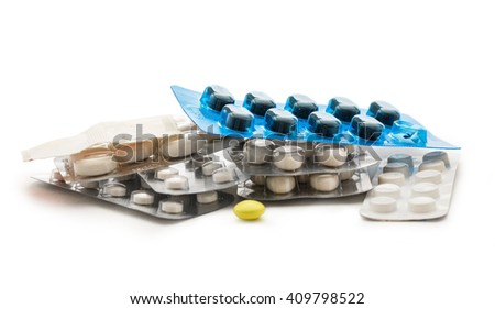 Packs with pills in closeup on white