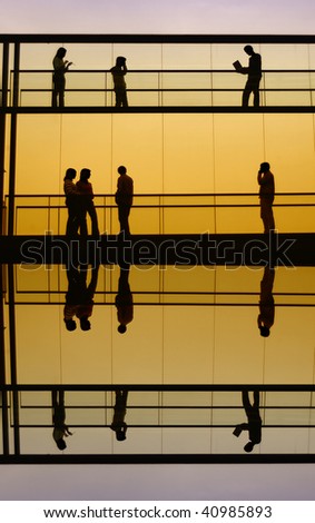 workers inside the office building silhouette at sunset