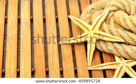 Starfish with rope on a wooden background
