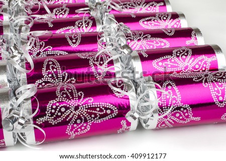 A studio shot of Crackers or otherwise known as Bon Bons.  A traditional cracker consists of a cardboard tube wrapped in a brightly decorated twist of paper with a gift in the central chamber.