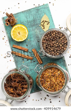 Spices and herbs in jars. Food, cuisine ingredients. Wooden board.