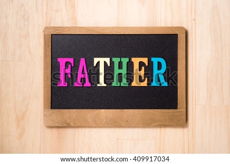 closeup of a chalkboard with the word FATHER letters in it