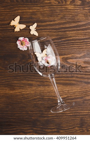 Wineglass with decorations on the wooden background
