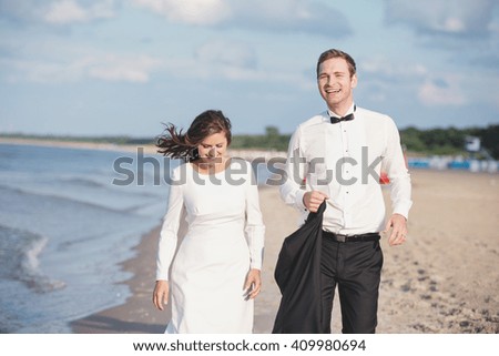 an image of portrait of beautiful bride and groom at the beach