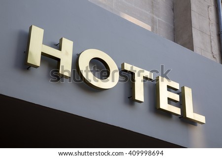 Gold Hotel Sign on Grey Background
