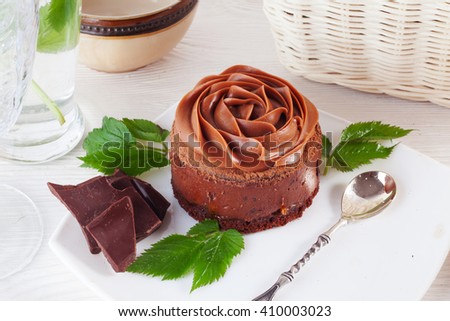 Rose chocolate mousse cake on a beautiful plate closeup cream