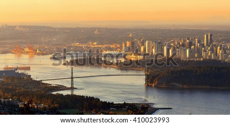 Vancouver sunrise with Lions Gate Bridge and skyscrapers in Canada.