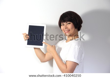 The asian woman showing tablet.