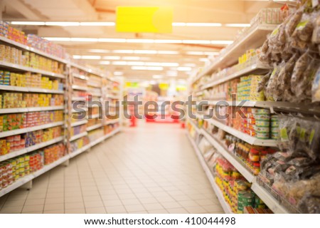 Supermarket Aisle and Shelves in blurry for background Royalty-Free Stock Photo #410044498