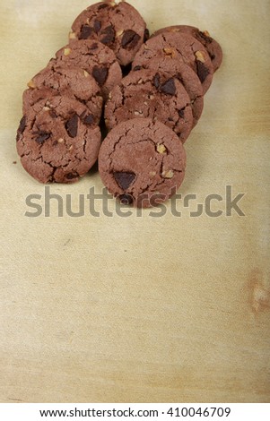 Traditional chocolate chip cookies with peanut on plain wooden table. Space for text. View top.