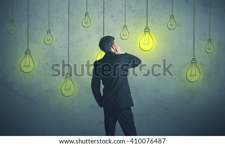 businessman with hanging lighting bulbs