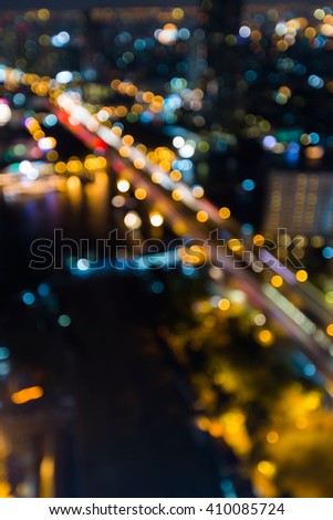 Night aerial view city downtown bridge cross river, abstract blurred bokeh lights 