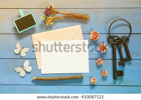 vintage mockup with flowers and blank letter on wooden background. vintage filtered and toned