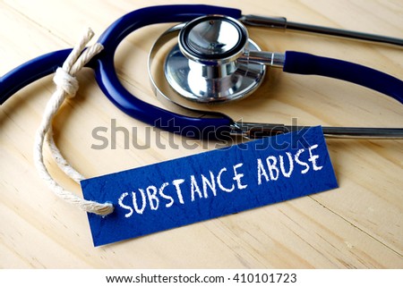 Medical conceptual image with SUBSTANCE ABUSE word written on label tag and stethoscope on wooden background. Royalty-Free Stock Photo #410101723
