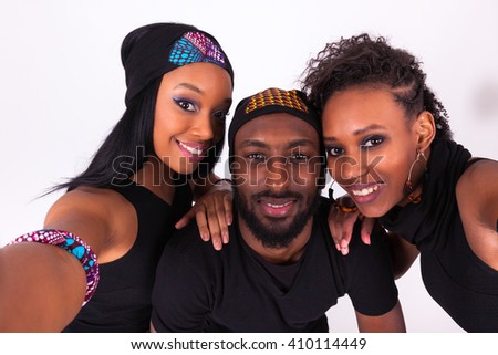 Group of African American friends taking a selfie portrait isolated over a gray background