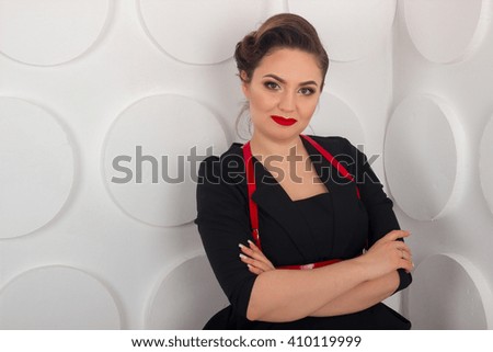 Close up of a woman in a black dreess on the white background