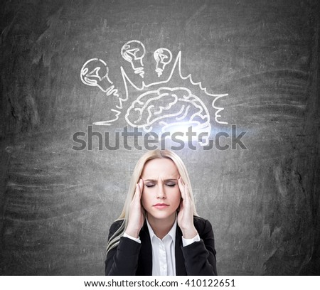 Brainstorming concept with stressed businesswoman and lightbulb and brain sketch on concrete wall