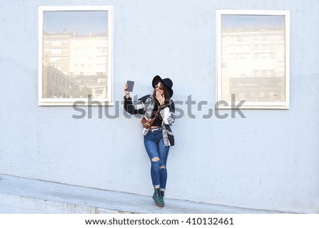 fashion girl with the tablet on the street