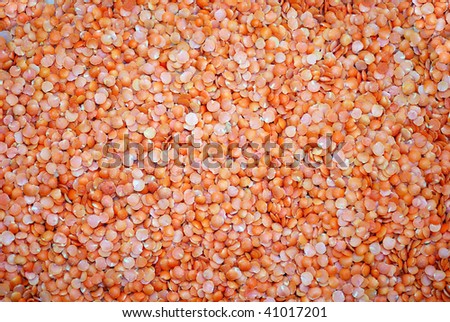 A background of red split lentils.