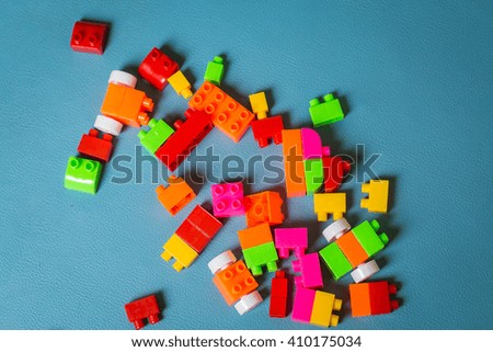 Colorful plastic toy blocks on blue screen