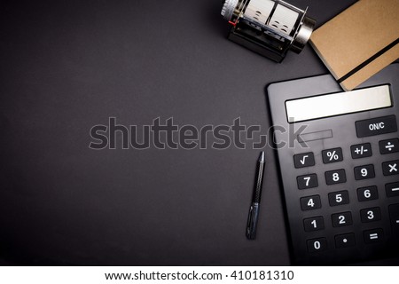 view of office space with business tools from above on black background with vignetting and copy space