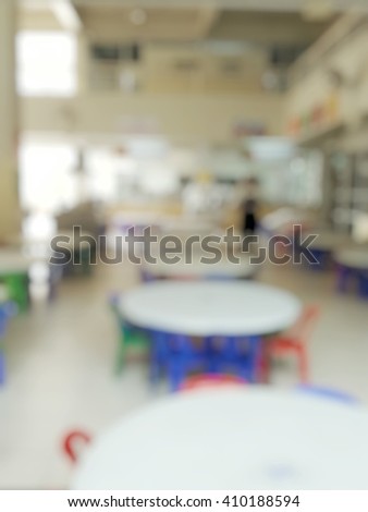 Blur abstract background of kindergarten canteen. Blurry view of round tables with chairs in cafeteria for elementary or primary students kids in school.