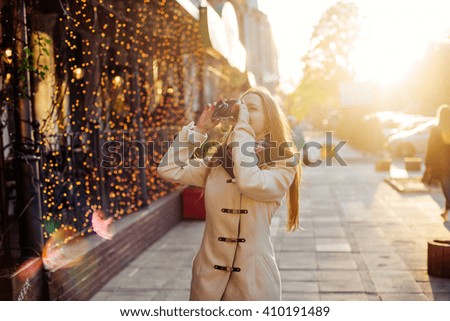 woman making photos of the city. female with vintage camera