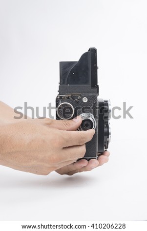 Man taking photo with vintage camera isolated on white background