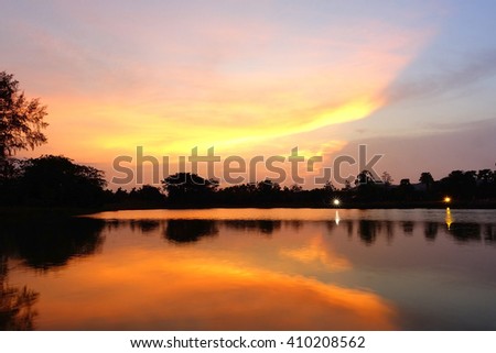 Abstract background from silhouette un focus image view of colorful sky reflex water in evening :ideal use for background.