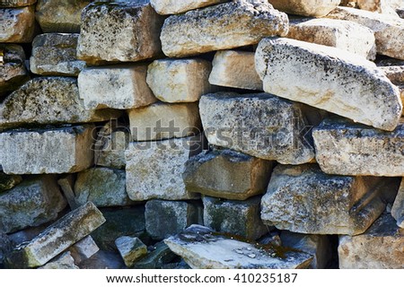 Stone blocks are grey in colour and pile. 