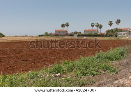 plowed field next to houses