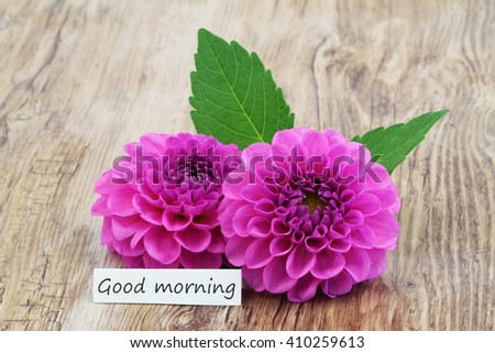 Good morning card with two pink dahlia flowers on wooden surface

