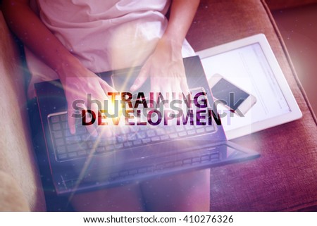 young woman typing at  TRAINING DEVELOPMENT  text on laptop. soft light with vintage filter. online marketing concept. Business concept. Business online