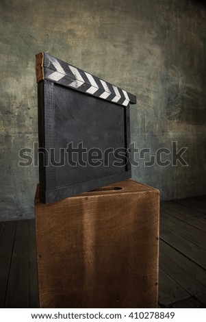 vintage photo of movie clapper on wood