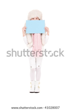happy girl in winter hat with blank board