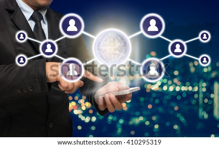 Businessman using the smart phone with the Social media symbol on Blurred Photo bokeh of cityscape, Elements of this image furnished by NASA, Business network concept