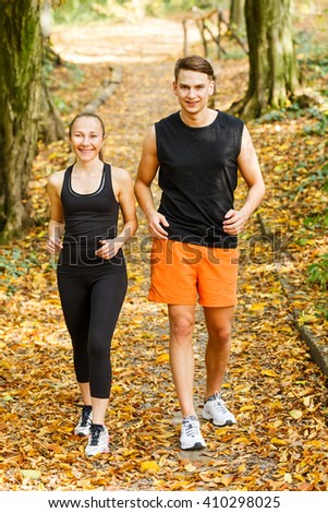 Photo of two happy young exercising outdoor runner 