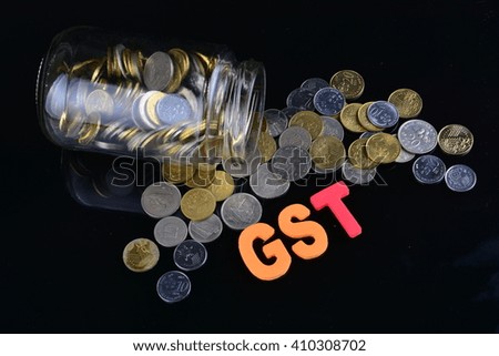 coins spilling from a money jar with word GST