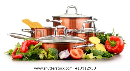 Set of pots and raw vegetables isolated on white background.