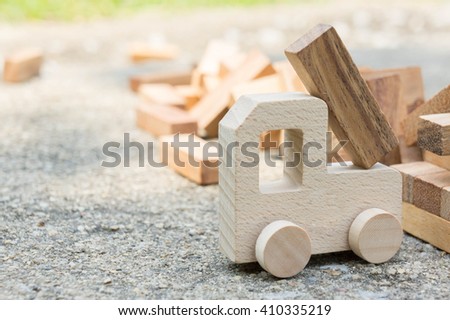 Wooden blocks and wood car with motivational message on attempt