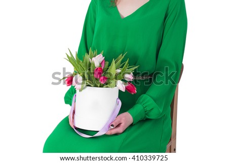 Beautiful young woman with a bouquet of flowers in a gift box. The idea and concept gift woman birthday, March 8, Valentine's Day and other romantic celebrations.