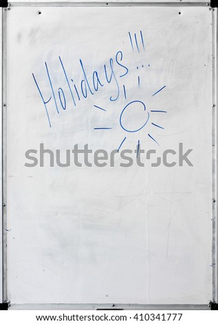 Dirty vertical whiteboard with the inscription "Holidays"