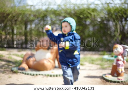 blur child runs on a walk in the playground