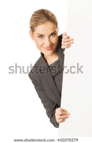Businesswoman holding empty billboard
