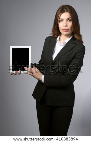 the business woman holds the tablet in hand