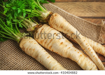 raw parsley roots on burlap napkin Royalty-Free Stock Photo #410404882