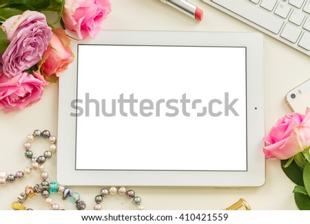 Styled desktop scene  with white tablet, mobile and pink flowers