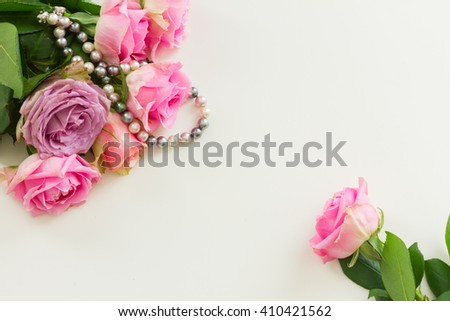 Styled desktop scene  with pink flowers, copy space on white table