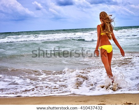 summer girl sea in yellow swimsuit